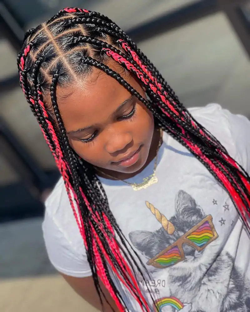 An African American Kid wearing box braids hairstyle. The braids are square-shapped, and rose pink highlighted.