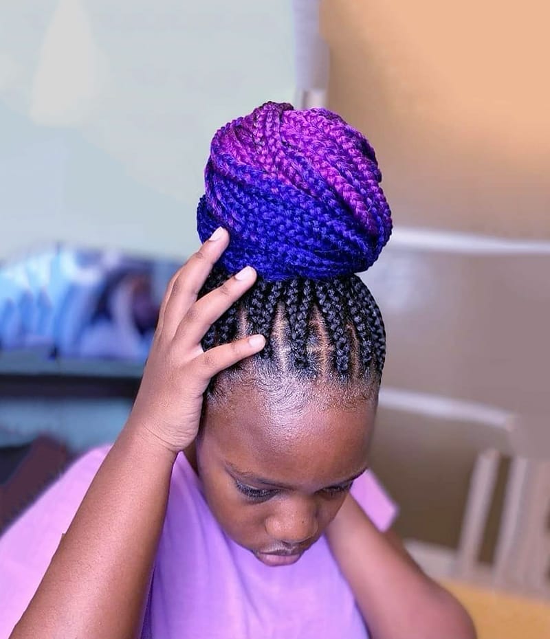 A 11 Year Old Black Girl is Wearing Blue and Pink Highlighted Braided High Bun Hairstyle with Box Braids.