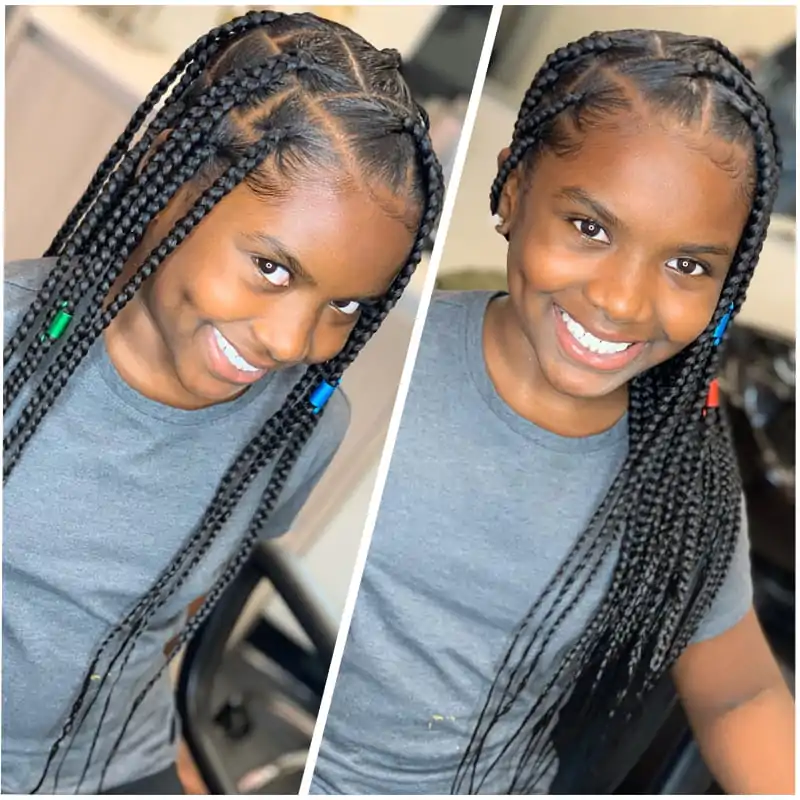 An African American Kid Wearing Long Knotless box braids , smiling.