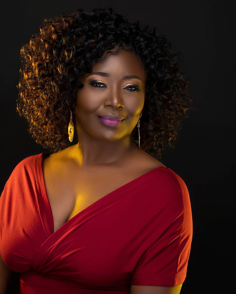An African American Women is Wearing Work-Friendly Corporate Curls