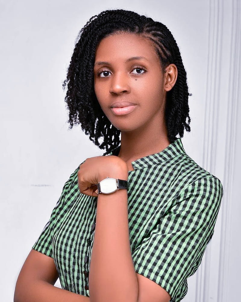 An African American Corporate Woman is Wearing Two-Strand Twist Outs, looking at the Camera