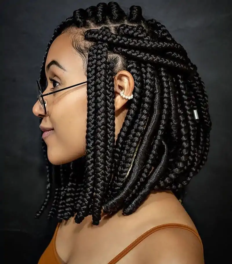 Pixie braids styled with a curly ponytail for added texture