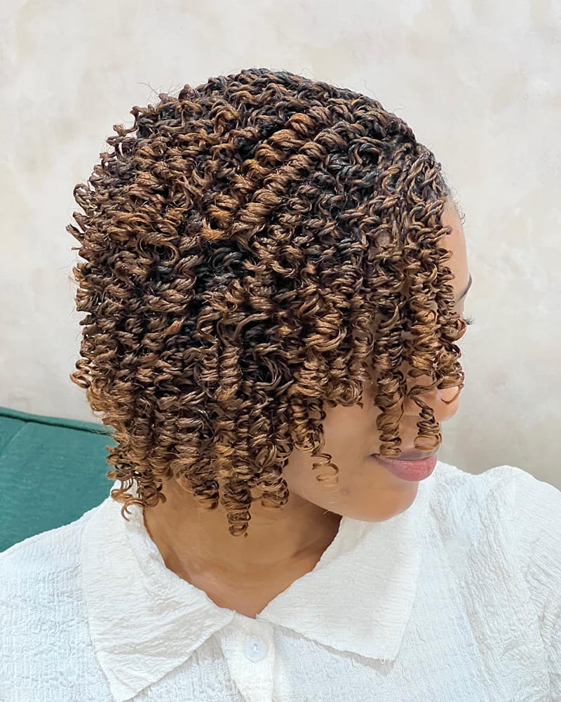 Curly pixie braids with cornrowed sides and a short braided finish
