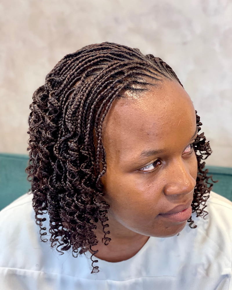 Feed-in cornrows at the front with short pixie braid ends