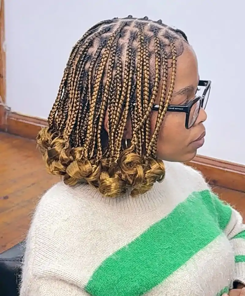 Honey blonde pixie bob with curled braid ends